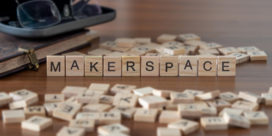 The concept of a school makerspace is represented by loose wooden tiles.